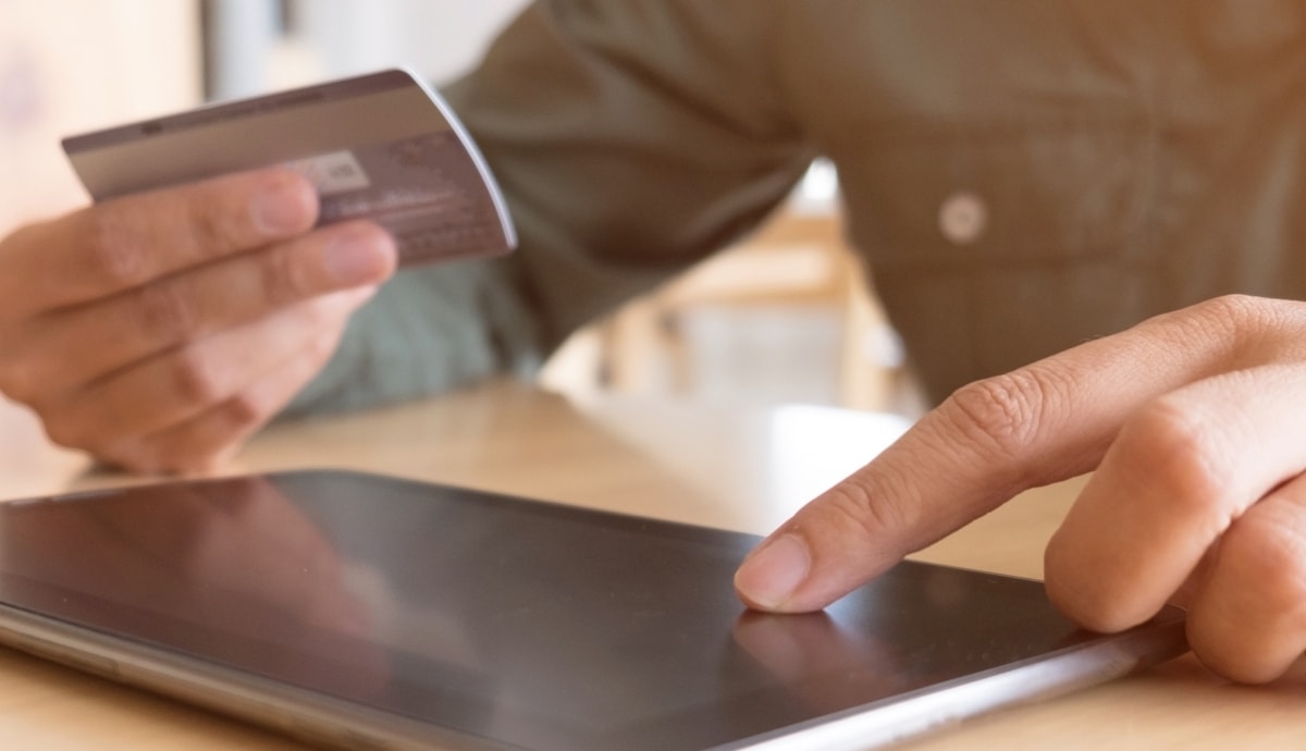 closeup of man making a donation on a tablet